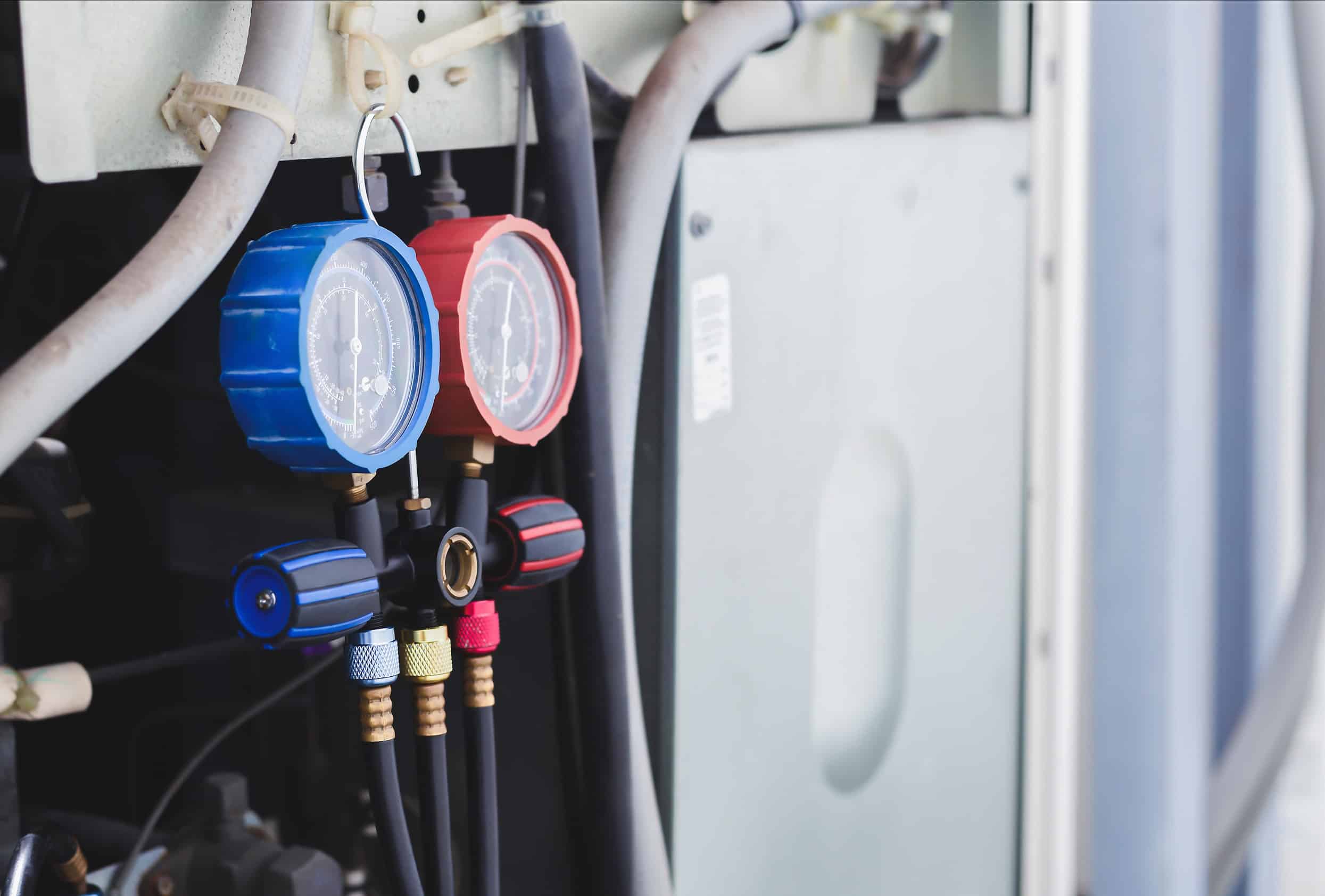 air repair mechanic performing maintenance on an outdoor system