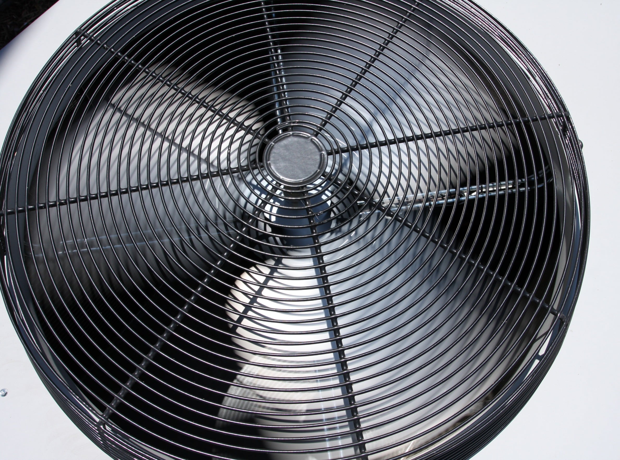 real close up of an outdoor hvac unit fan blades moving fast