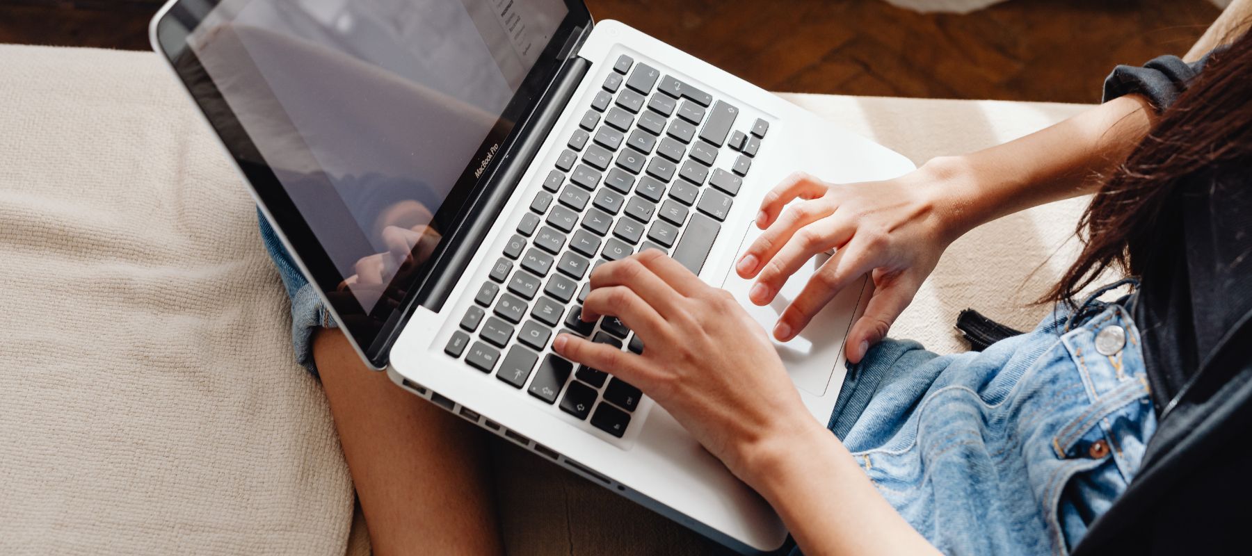 person typing on their computer to contact thayer for air conditioning and heating services in new braunfels, texas