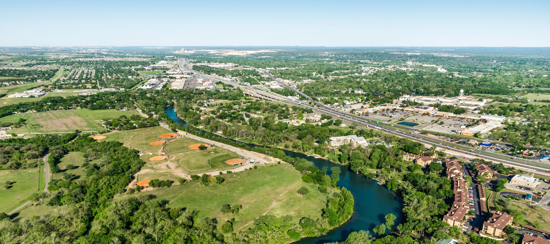 aerial overview of new braunfels with parts of the city and the river showing