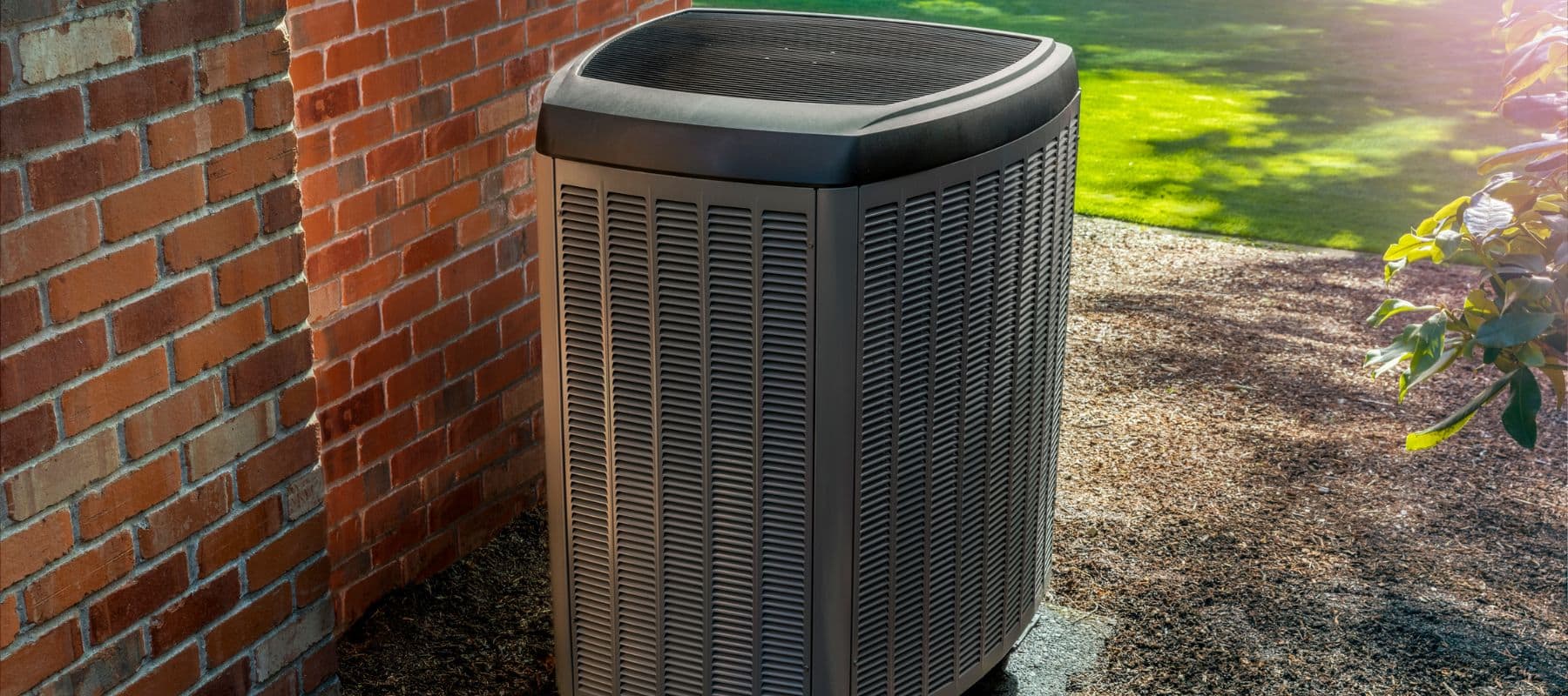 closeup of a heat pump installed on the side of a red brick new braunfels home